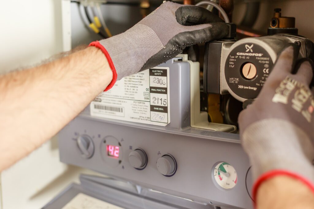 Man repairing power source wearing grey gloves